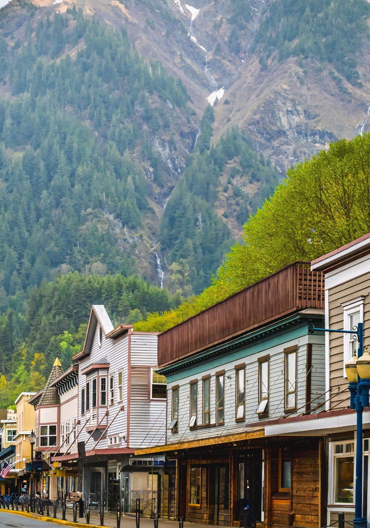 Charming small town street with mountain backdrop on a clear day.